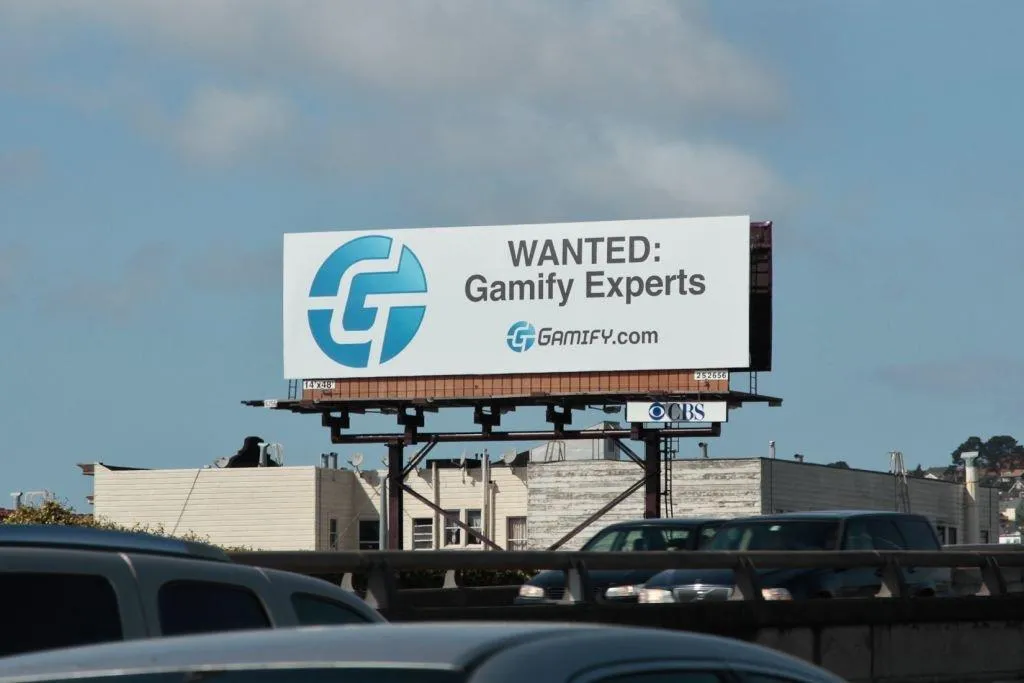 A roadside billboard in San Francisco reading: Wanted, Gamify Experts, Gamify.com