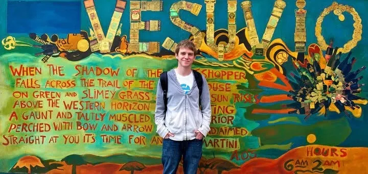 Nathan Lands as a young man, standing in front of the painted Vesuvio mural in North Beach